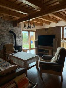 a living room with a table and a tv at Slnečný domček Sučany in Sučany