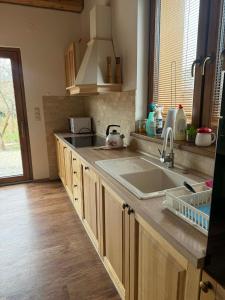a kitchen with a sink and a counter top at Slnečný domček Sučany in Sučany +16 photos