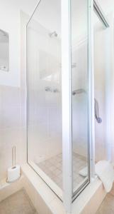 a shower with a glass door in a bathroom at Lloyd Road Cottage in Port Elizabeth +4 photos