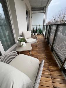 a balcony with two chairs and a table on a building at SPV Rentals Premium Apartament Wołoska 3 in Warsaw +18 photos