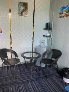 two chairs and a table in a room at Tawan Resort in Bophut