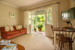 a living room with a couch and a table at Lloyd Road Cottage in Port Elizabeth