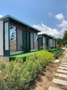a row of cottages with plants in front of them at Tawan Resort in Bophut