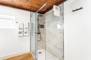 a shower with a glass door in a bathroom at GuestReady - Quinta da Devesa in Vila Nova de Gaia