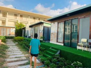 a person walking in front of a building at Tawan Resort in Bophut