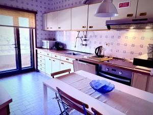 a kitchen with a table with a blue bowl on it at Garrett by the Sea in Vila do Conde