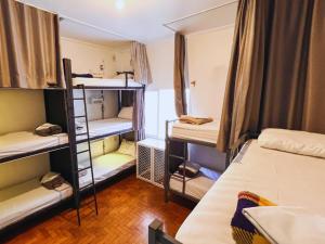 a room with several bunk beds in a dorm room at Lamparina Hostel in São Paulo