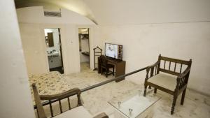 a living room with a couch and a chair at Kasr-i Nehroz Hotel in Midyat