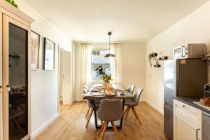 a kitchen and dining room with a table and chairs at LEVEL22 ! Groß & Modern, Parkplatz, Balkon, Küche in Leverkusen