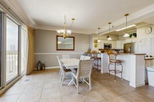 a kitchen and dining room with a table and chairs at Beachfront Condo with Balcony Pools and Gym in Destin