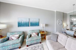 a living room with two chairs and a couch at Gulf-Front Condo with Pools and Gym in Destin