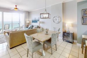 a living room with a table and a couch at Gulf-Front Condo with Pools and Gym in Destin