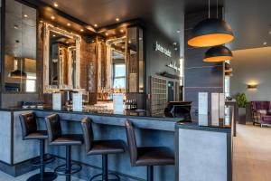 a bar in a restaurant with stools at Premier Inn Berlin City Spittelmarkt in Berlin