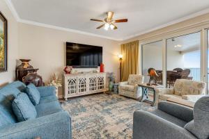 a living room with two blue couches and a fireplace at Relaxing Waterfront Condo with Pools & Gym Access in Destin