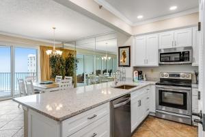 a kitchen with white cabinets and a counter top at Relaxing Waterfront Condo with Pools & Gym Access in Destin +33 photos