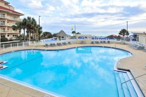 a large pool with blue water in a resort at Relaxing Waterfront Condo with Pools & Gym Access in Destin