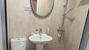 a bathroom with a toilet and a sink and a mirror at Kutchak AparanQ in Kʼuchʼak