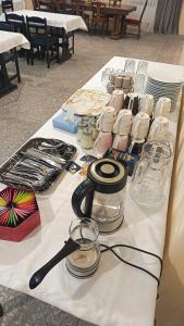 a table with a white table cloth with glasses at Kutchak AparanQ in Kʼuchʼak +17 photos