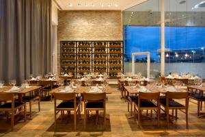a dining room with tables and chairs and wine racks at Venit Mio Hotel in Rio de Janeiro