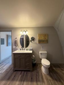 a bathroom with a toilet and a sink and a mirror at Bryce Glamp And Camp in Cannonville +172 photos
