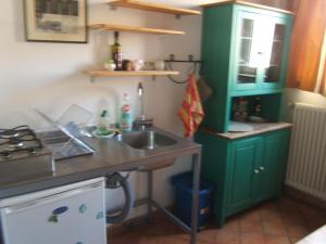 a kitchen with green cabinets and a sink at Olivella Suite Ecological House in Palermo +18 photos