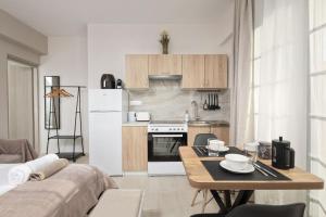 a small kitchen with a table and a refrigerator at Katerina's Sunset Apartment in Episkopianá