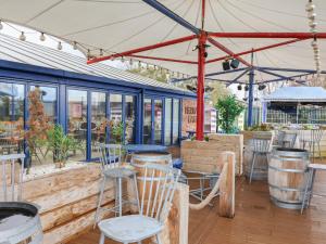 a patio with chairs and tables under a tent at Winchester - 244 in Rhyl