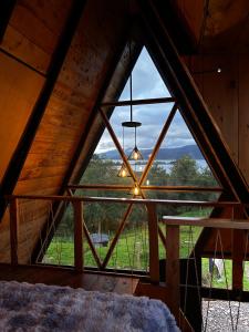 a room with a large window in a cabin at Chalet - Laguna de la Cocha in Pasto