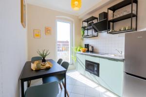 a small kitchen with a small table and a dining room at BetterBeds Wilhelm City in Brandenburg an der Havel +45 photos