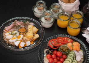 a table with two plates of food and glasses of orange juice at High Life Aparts in Warsaw +23 photos