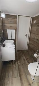 a bathroom with a sink and a tub and a toilet at Casa da Avó Biza in São Roque do Pico +9 photos