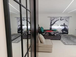 a living room with a bed and a window at Apartment Bogunovic in Bar