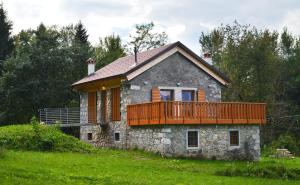 a house with a deck on top of a hill at Albergo Diffuso Tolmezzo in Tolmezzo