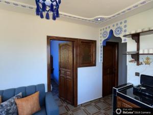 a living room with a blue and white wall at dar naim in Chefchaouen