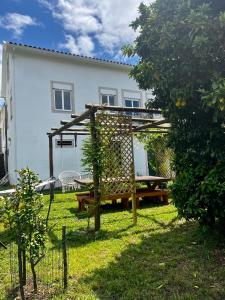 a garden with a bench and a picnic table at B&B by the River Beach in Mega Fundeira