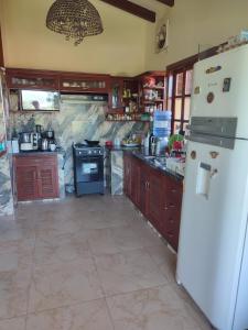 a kitchen with a white refrigerator and a stove at Gästehaus Samaipata in Samaipata +24 photos