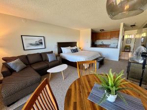 a living room with a couch and a bed at Beachfront King Bed Studio Suite in Qualicum Beach