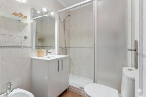 a white bathroom with a sink and a shower at Casa Marbella in Fuengirola +12 photos