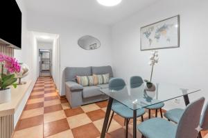 a living room with a couch and a table and chairs at Casa Marbella in Fuengirola