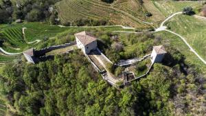 an aerial view of an old house on a hill at Le Torri di Credazzo in Farra di Soligo