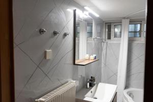 a white bathroom with a sink and a mirror at Sea Breeze Alexandroupolis in Alexandroupoli +71 photos