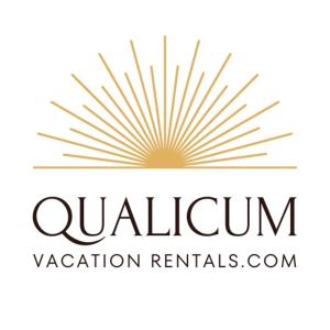 a logo for a vacation rental company with a sunburst at Oceanfront Studio with Loft - amazing views! in Qualicum Beach +24 photos