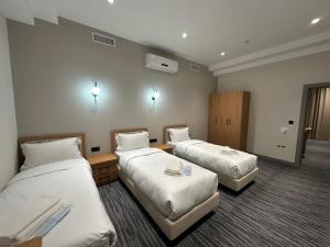 a hotel room with two beds in a room at Velnora Hotel in Tashkent +91 photos