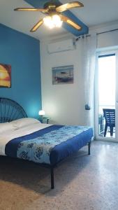 a blue bedroom with a bed and a ceiling fan at Villa Grace Amalfi seaview Jacuzzi in Amalfi +74 photos