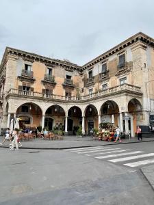 a large building with people walking in front of it at MAZZINI LUXURY JACUZZY SUITE Catania in Catania