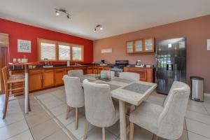 a kitchen with a dining room table and chairs at Arantxa Residence in Noord