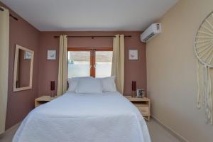 a bedroom with a white bed and a window at Arantxa Residence in Noord