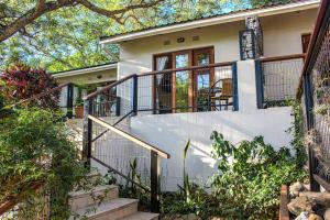 a home with stairs leading up to a house at Kruger's Rest Guest House in Hazyview