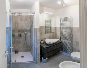 a bathroom with a shower and a sink and a toilet at La Perla sul Lago in Pescate +51 photos