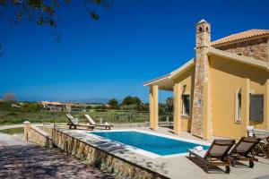 a villa with a swimming pool and a house at Estrellas Luxury Villas in Svoronata +52 photos